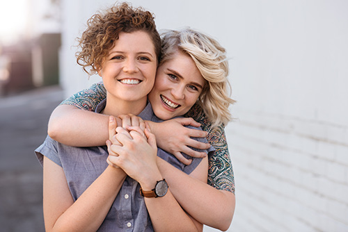 Smiling lesbian couple embracing